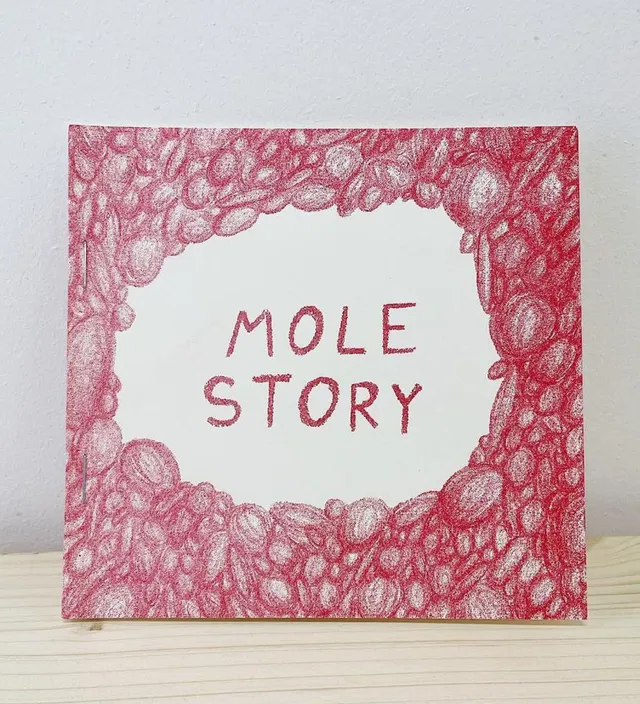 Mole Story book cover drawn in red coloured pencil