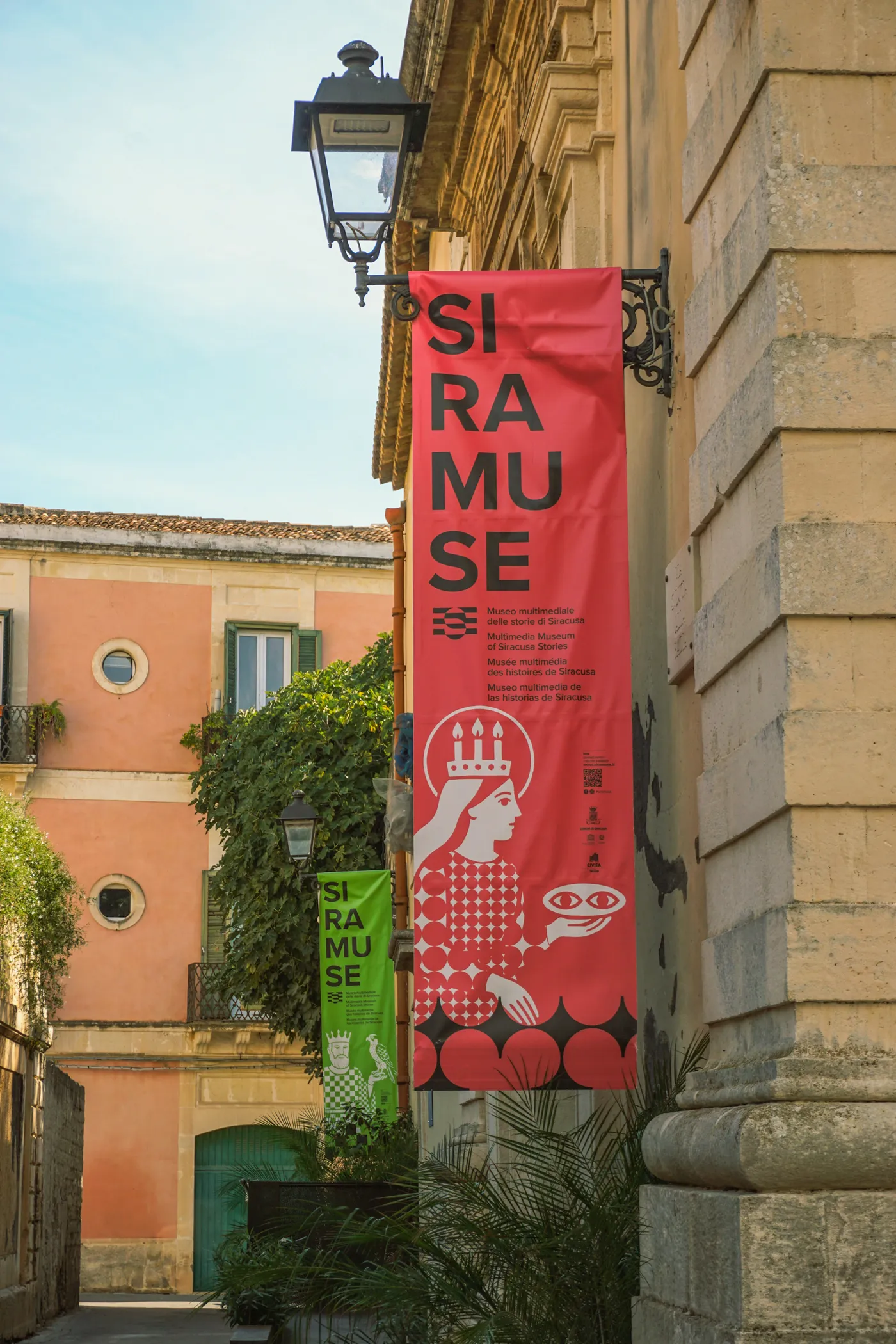 Red Siramuse banner with the Saint Lucy character